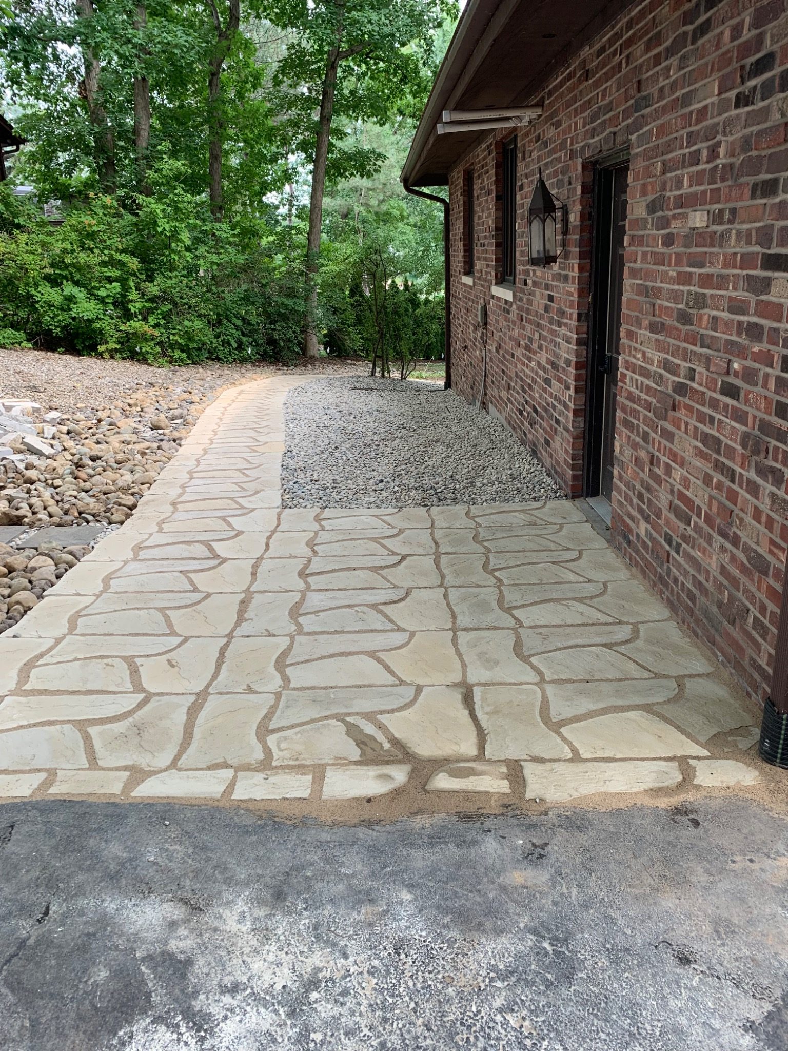 Stone walkway beside brick home